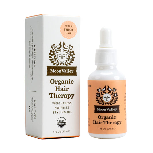 Moon Valley Organics Hair Therapy bottle close-up highlighting hydrating oils