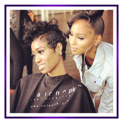 Pouring the detangler bottle evenly to distribute moisture through hair.