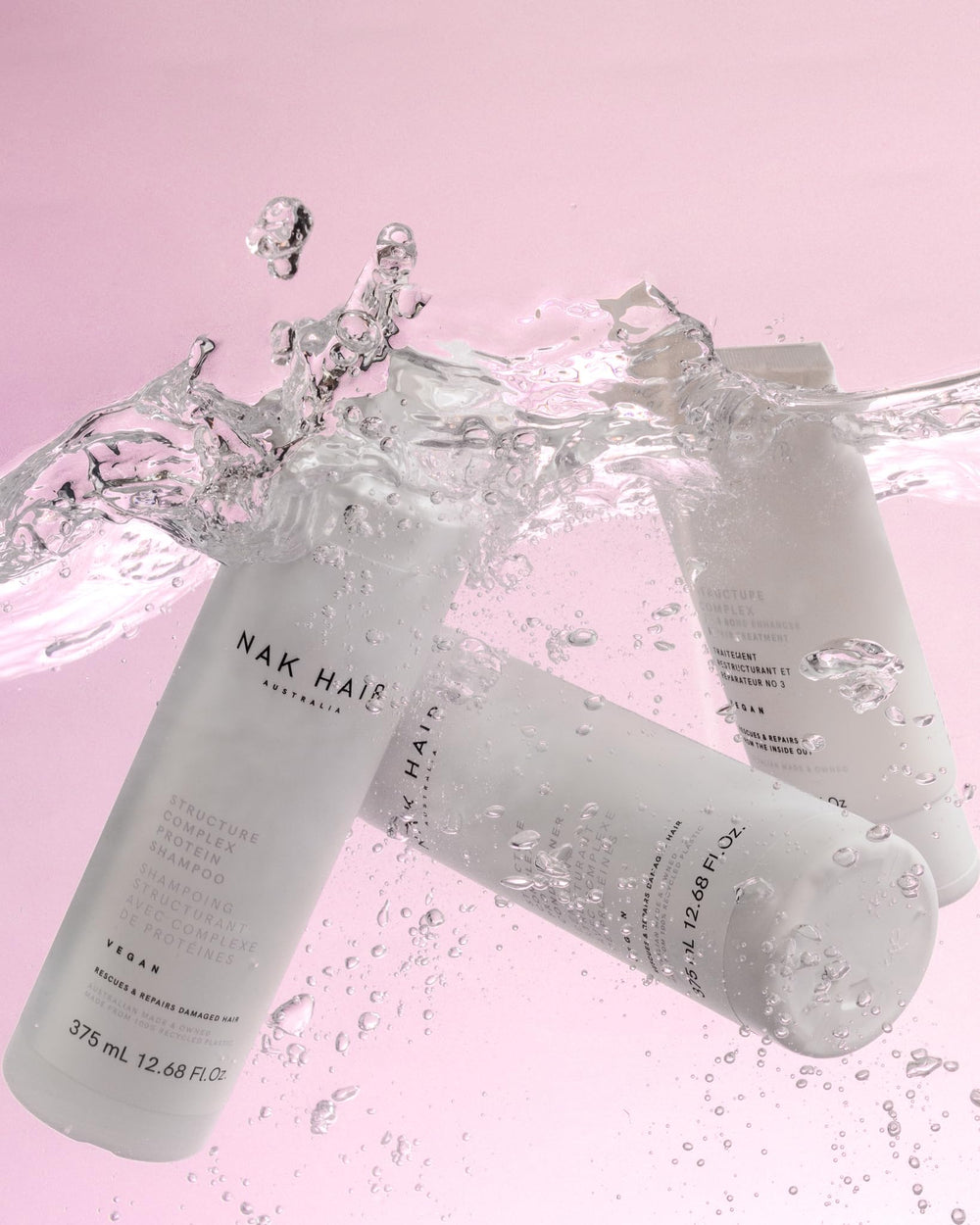 NAK Hair Structure Complex Shampoo pour showing smooth cleansing and effortless styling.
