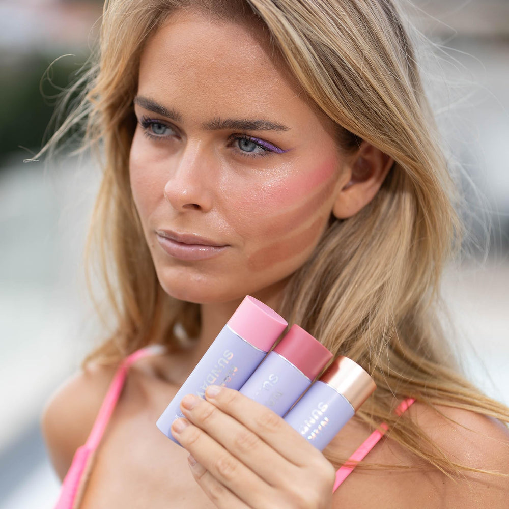 Naked Sundays SPF50 glow balm on lips shows tinted moisture and sun protection.