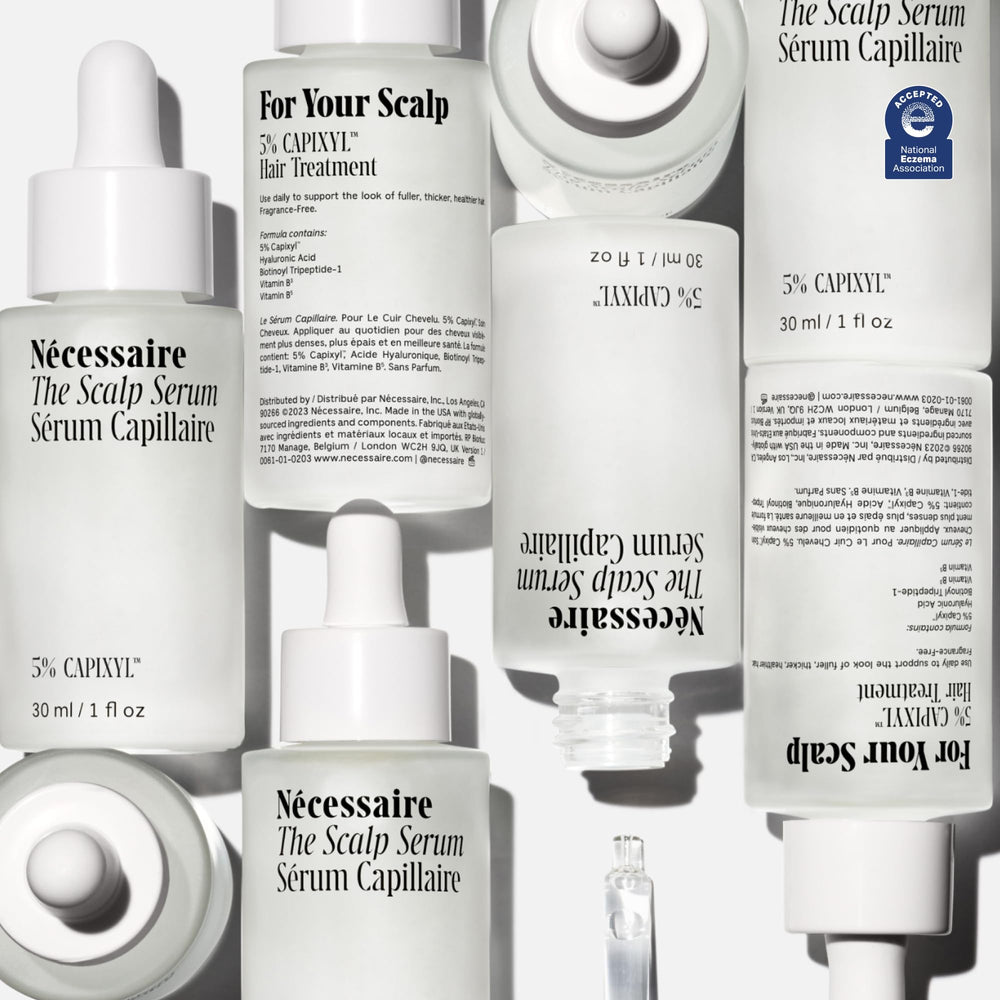 Nécessaire Scalp Serum on dry scalp area, soothing daily care.