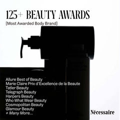 Nécessaire Shampoo Mini closeup with hyaluronic acid highlights deep hydration during wash.