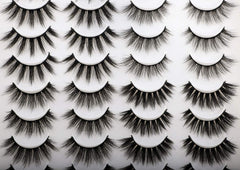 Newcally easy-apply lashes demonstrated with tweezers for quick application.