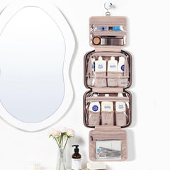 NISHEL travel toiletry bag opened to reveal four interior compartments