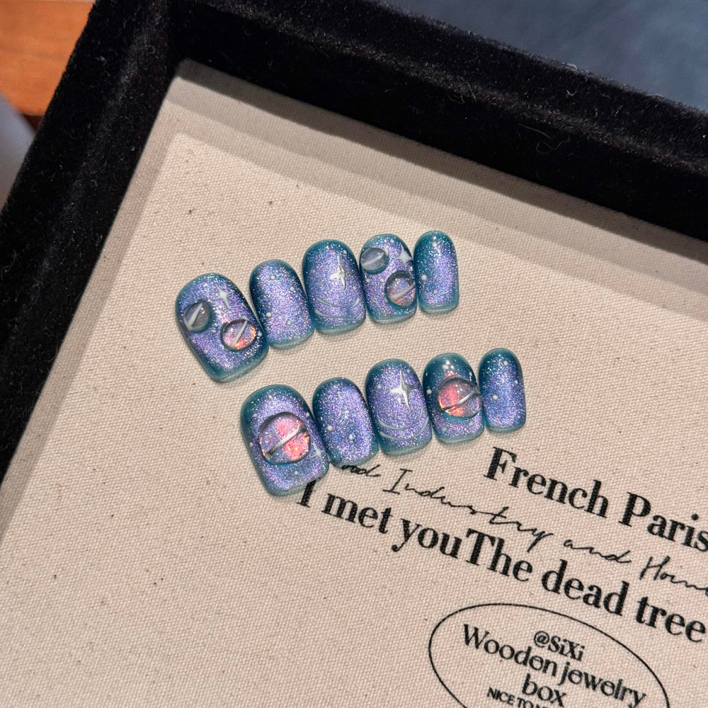NLSJMP cosmic planet nails in blue and purple, bold everyday style.