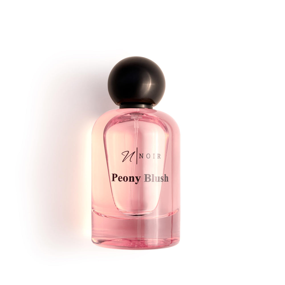NOIR Peony Blush bottle side, suede vibe echoes luxurious warmth