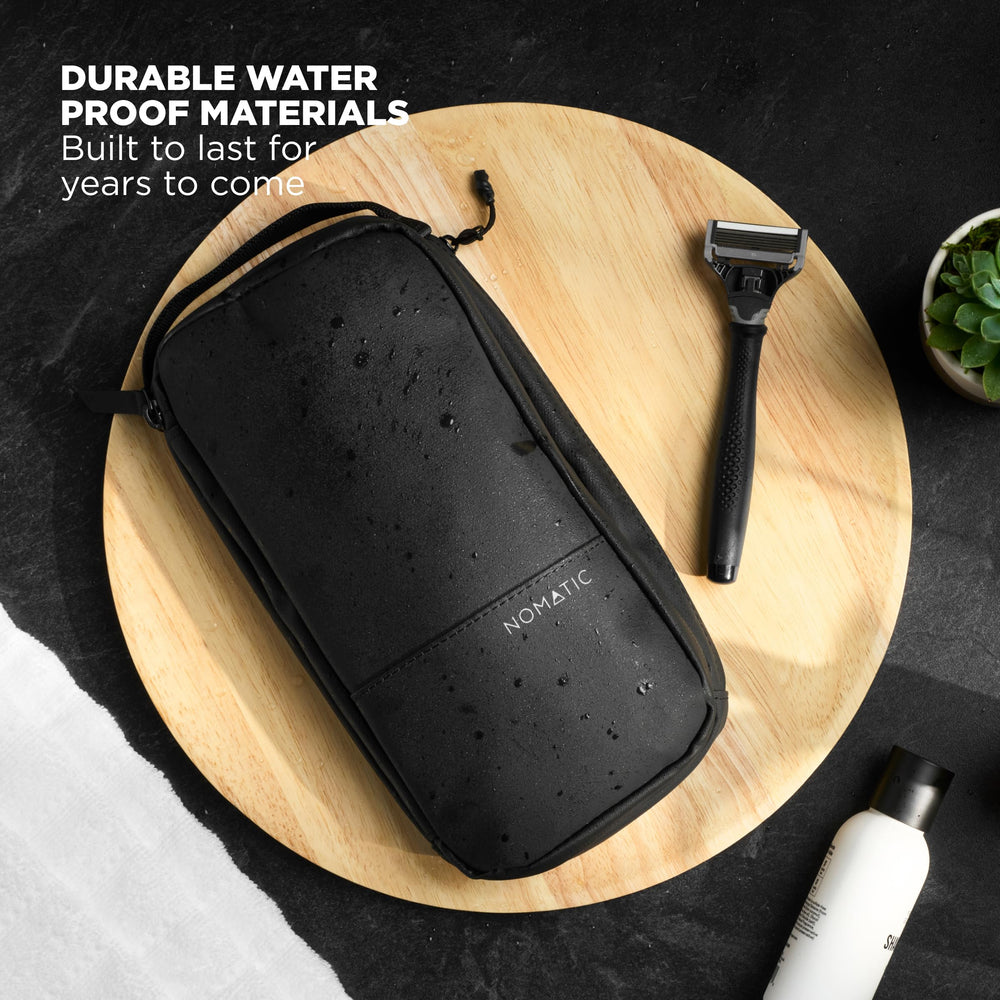 NOMATIC navy wash bag complements both men's and women's travel ensembles.