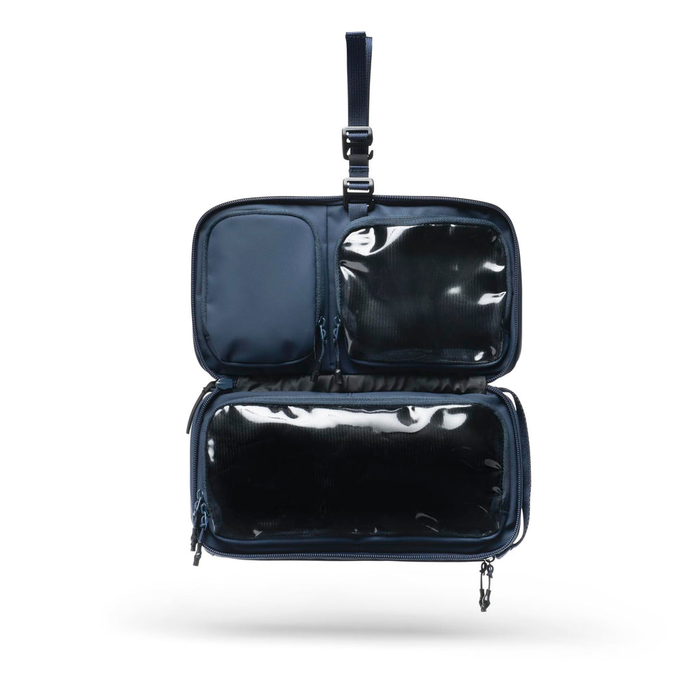 NOMATIC Navy travel bag with water-resistant fabric protects contents from splashes and rain.