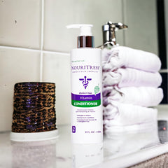 NouriTress Vitamin Conditioner avocado oil detail highlights deep moisture.