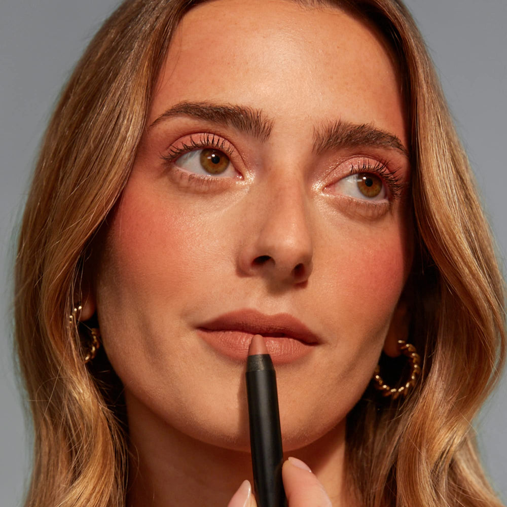Nudestix Intense Matte Lip + Cheek Pencil being applied on lips for smooth color.