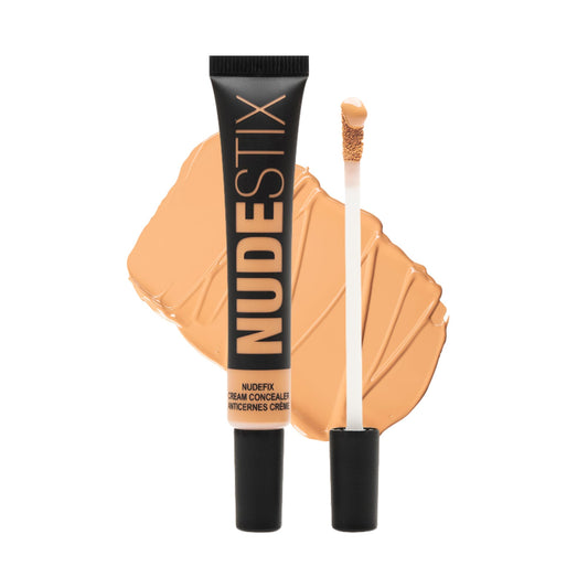 Nudestix Nudefix Cream Concealer under-eye application brightens dark circles for a refreshed look.
