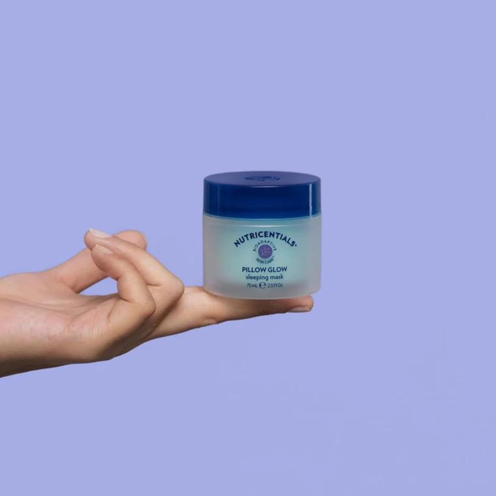 NuSkin Pillow Glow bottle display with bioadaptive botanicals for resilient skin.