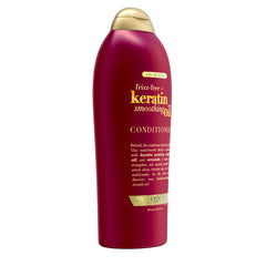 OGX Frizz-Free + Keratin Smoothing Oil Conditioner bottle label highlights paraben-free and sulfate-free surfactants
