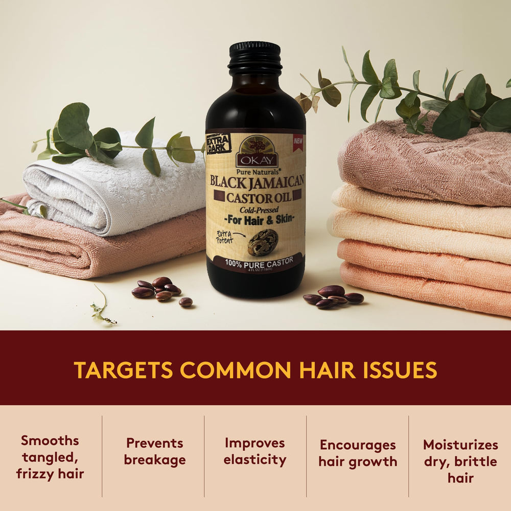 OKAY Pure Naturals oil next to towel and brush for hair care routine