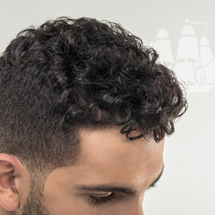 Old Spice Wavy Curly Leave-In Bottle helps reduce frizz and define curls.