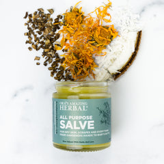 Hands applying Ora's Amazing Herbal salve for daily moisture