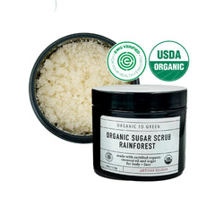 Organic To Green Rainforest Sugar Coconut Oil Scrub jar shows moisturizing texture that absorbs without greasiness