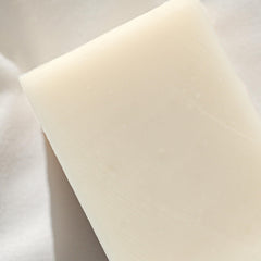 Close-up of Naked Body Soap texture showing creamy lather.