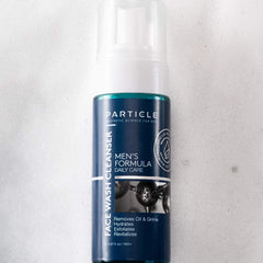 Particle Mens Face Wash pump dispenser on bathroom shelf for easy access.