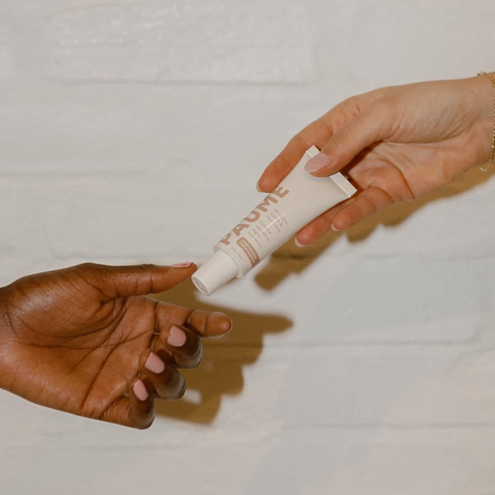 PAUME compact 0.75oz tube on desk shows travel-friendly size