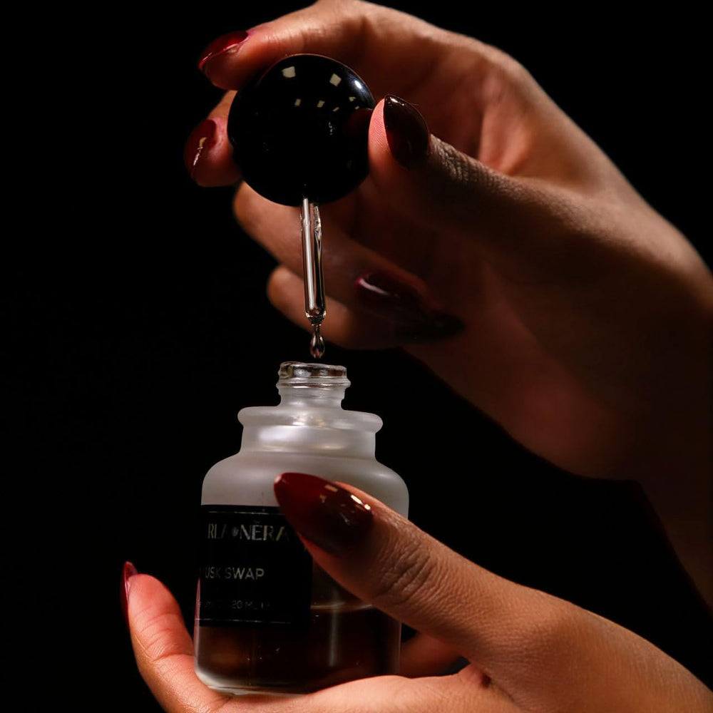 PEARLANERA Musk Swap amber bottle under soft light suggests enduring fragrance throughout the day.