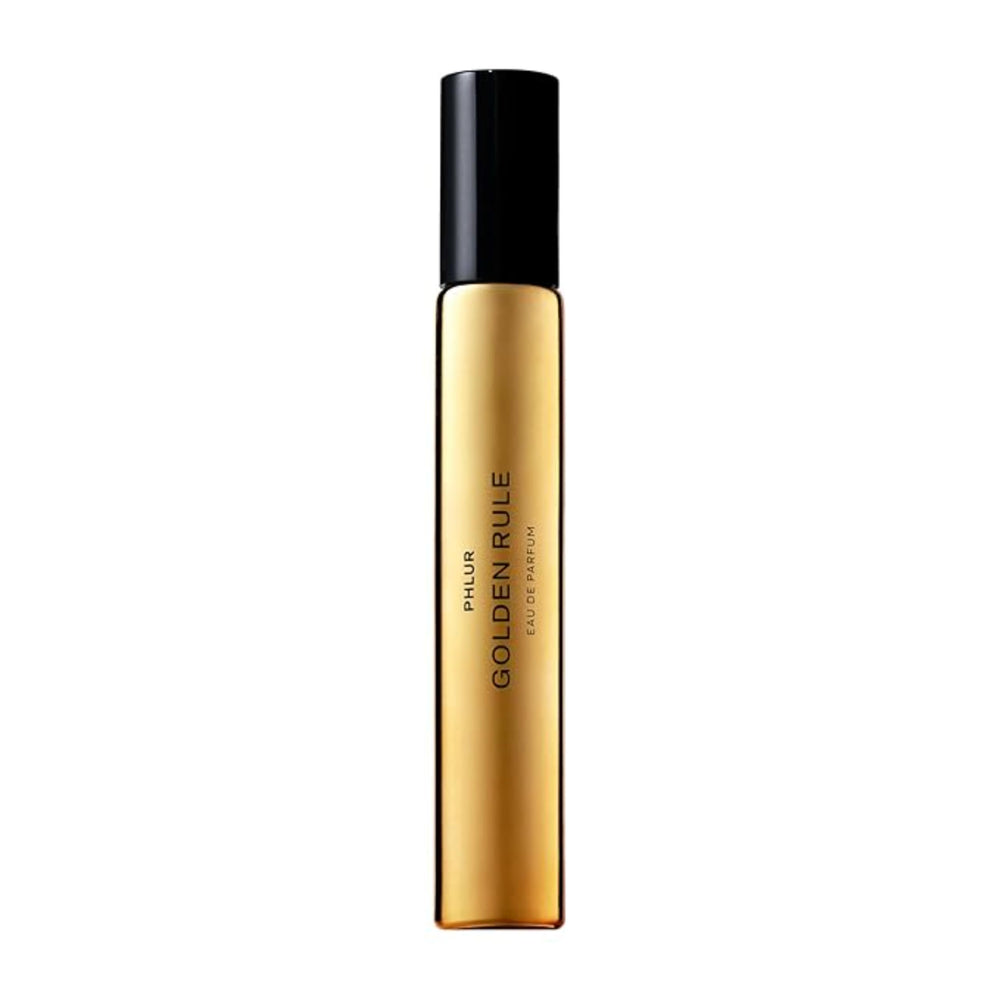 PHLUR Golden Rule bottle close-up with sleek glass for travel-friendly use.