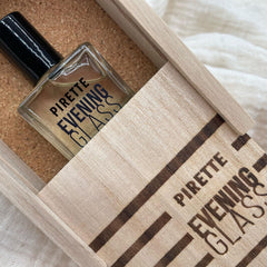 PIRETTE Evening Glass bottle on a sandy beach backdrop