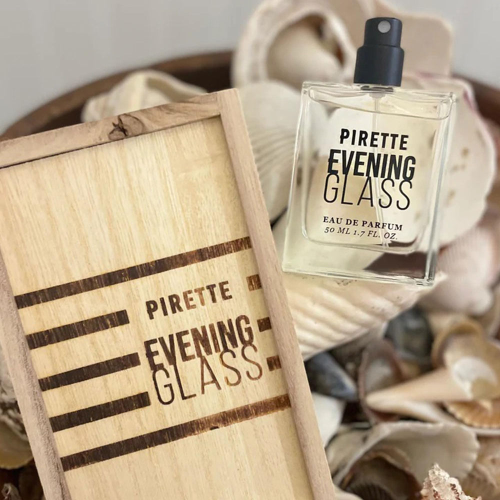 PIRETTE Evening Glass sea-salt note bottle against sunset