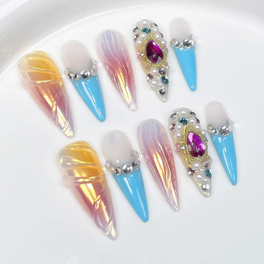 Qicaijia luxury press-on nails in stiletto-ombre with rhinestones for a glamorous look.