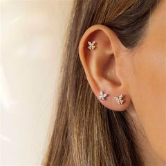 QWALIT waterproof earmuffs protect skin during piercing sessions.