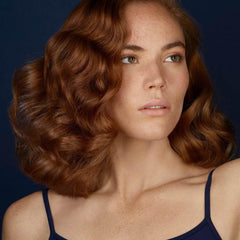 R+Co BLEU bottle cap close-up highlighting volume and strength
