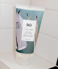 R+Co Cool Wind hair application scene suggesting smoothing and frizz reduction after air drying