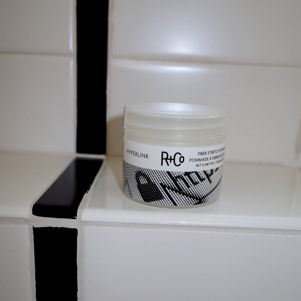 Hands applying R+Co Hyperlink for easy texture and hold