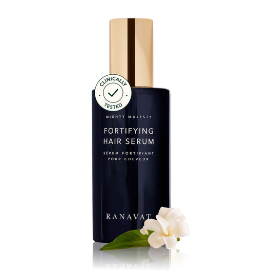 RANAVAT BOTANICS Mighty Majesty bottle pouring for scalp hydration and frizz control.
