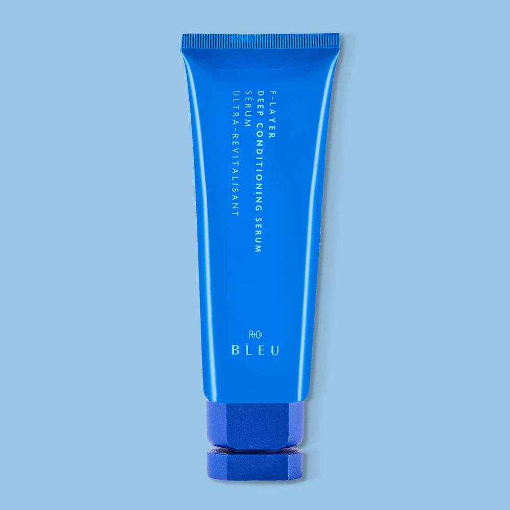 R+Co BLEU F-Layer silky fluid applied to hair for conditioning.