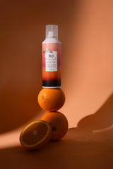R+Co Sun Catcher leave-in mist applied to damp hair for hydration and heat protection