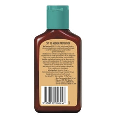 REEF Dark Sun Tan Oil Coconut 125ml – application shot, ideal for beach days and daily moisture.