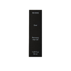 REVERIE Ever Recovery Oil on hair during application highlights smooth strands.