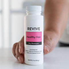REVIVEEO dry shampoo powder applied to hair for instant refresh without water.