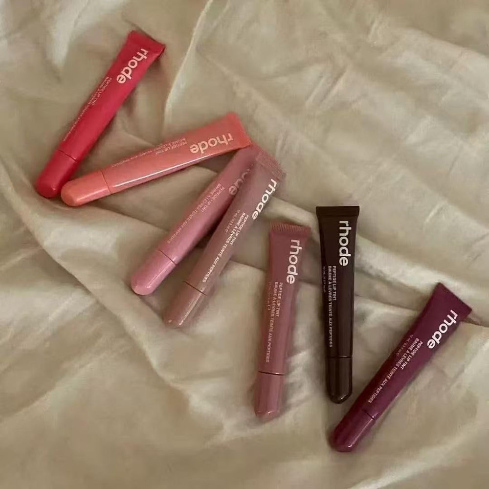 Application on lips demonstrates lightweight shine from Rhode Gloss Lip Tint Toast