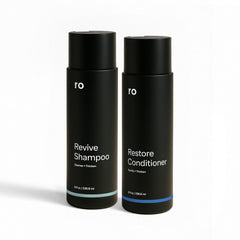 Ro Men's Revive Shampoo bottle on bathroom counter for thicker-looking hair.
