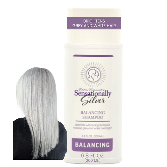 Robin Norwood's Sensationally Silver Balancing Shampoo bottle on a bathroom shelf for balanced silver tones.