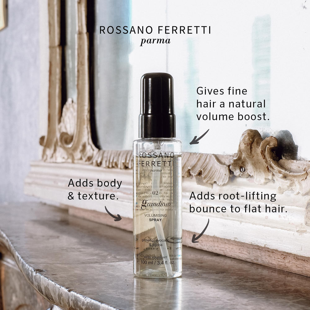 Grandioso Volumizing Spray mist applied to hair for lift and volume.