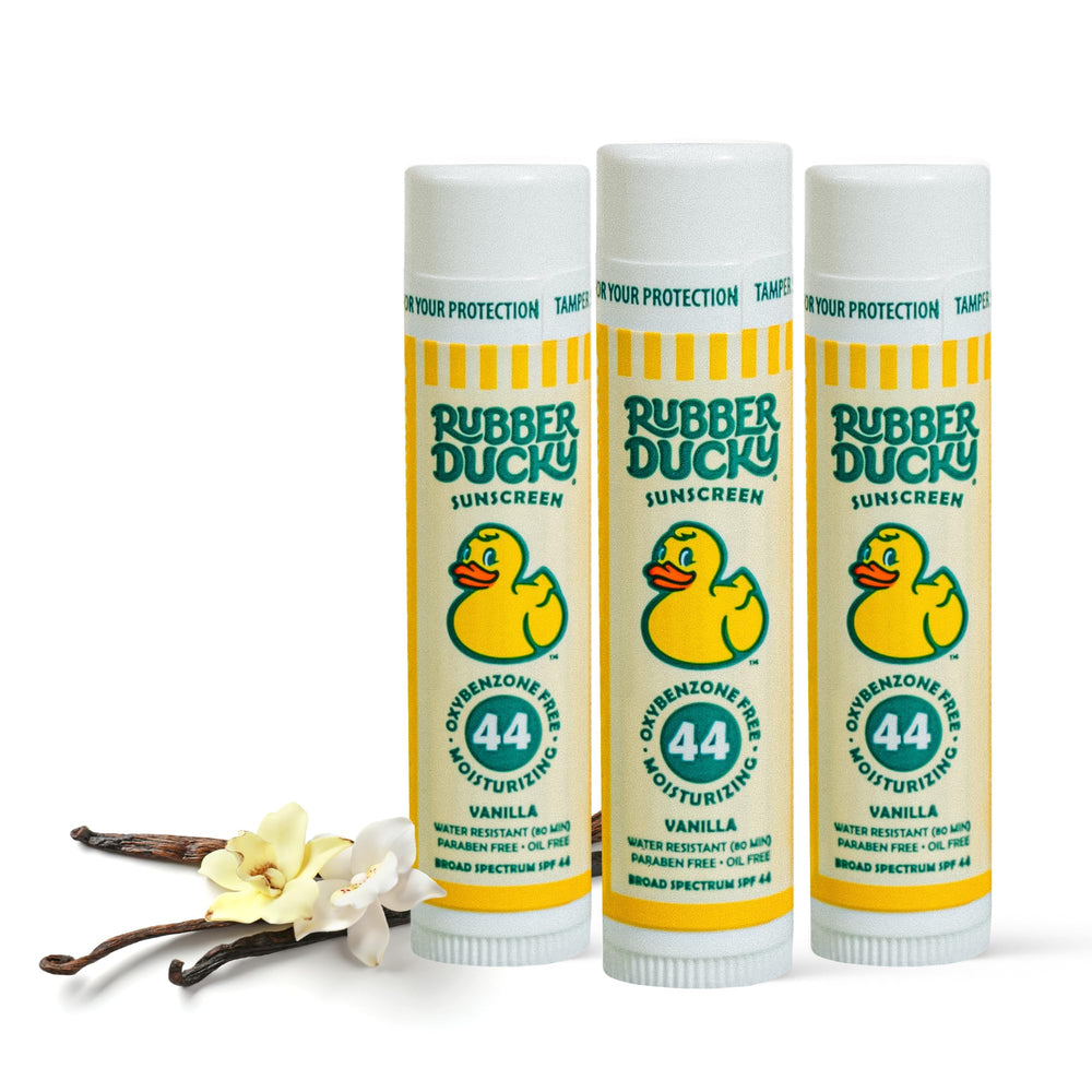 Rubber Ducky SPF 44 lip balm at the beach protects and hydrates lips.