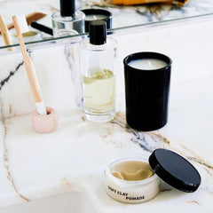 Rudy's Soft Clay Pomade hands warming to activate pliable texture.