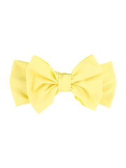 RuffleButts Banana Swim Bow Headband worn by a child, playful poolside accessory for sun-safe style.