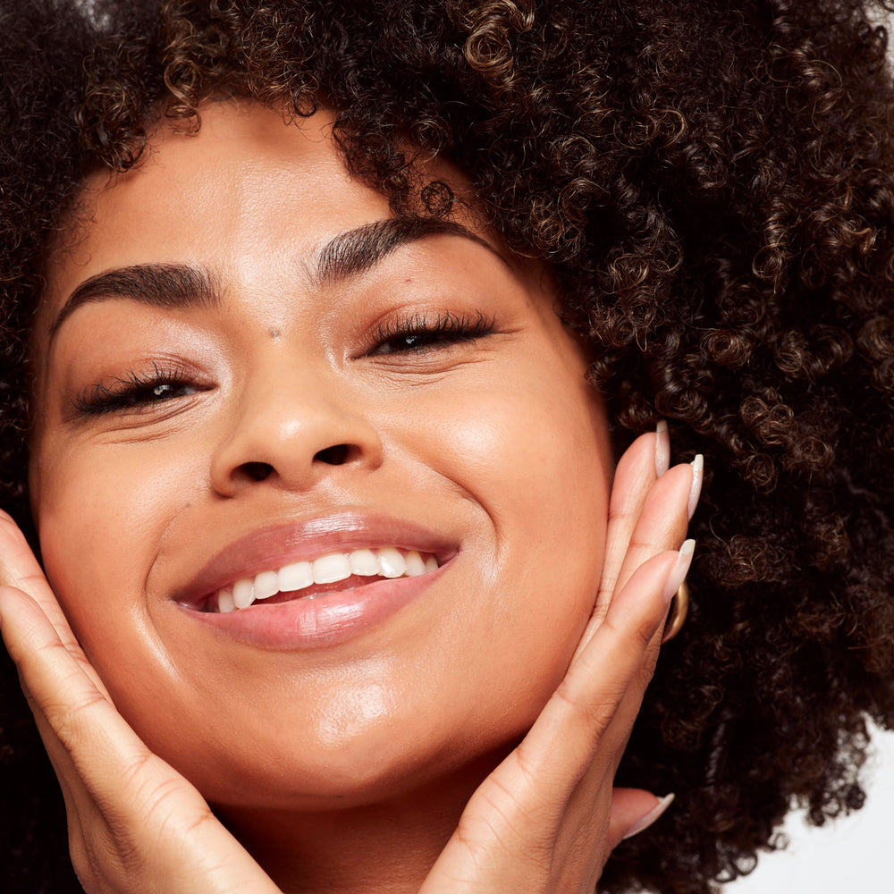 Saie Glowy Super Skin Tint shade 19 on the cheek for dewy radiance.