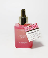 Sand + Fog Strawberry Spritz close-up label highlights oil-based formula for lasting wear