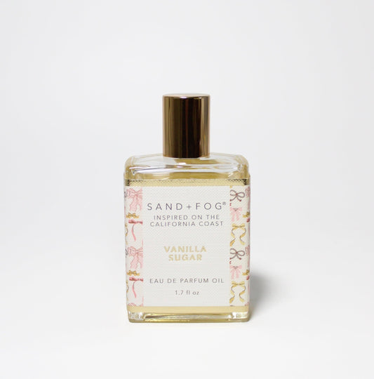 Sand + Fog Vanilla Sugar bottle with pink and gold accents, elegant coastal fragrance.