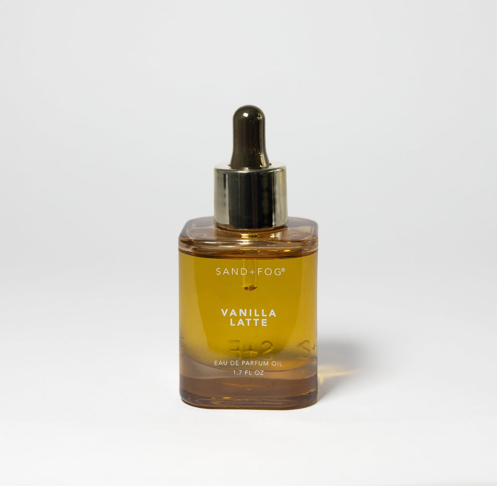 Close-up of Sand + Fog Vanilla Latte parfum oil bottle with amber glass for cozy notes.